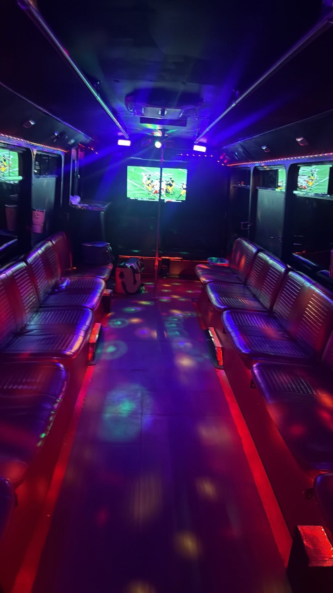 Interior of the DTS party bus lit with red and blue disco lighting
